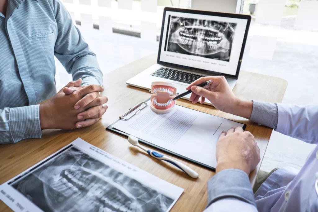 Doctor pointing at model teeth